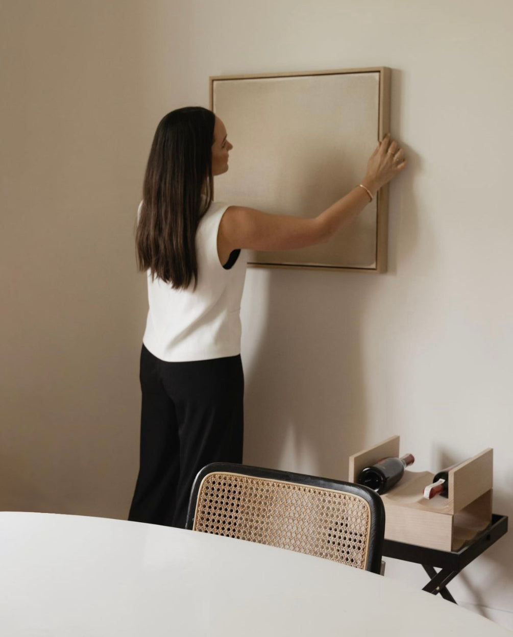 Influencer Beck Wadworth hanging her original fine artwork piece by Michelle Witters 'Poetic Interlude'